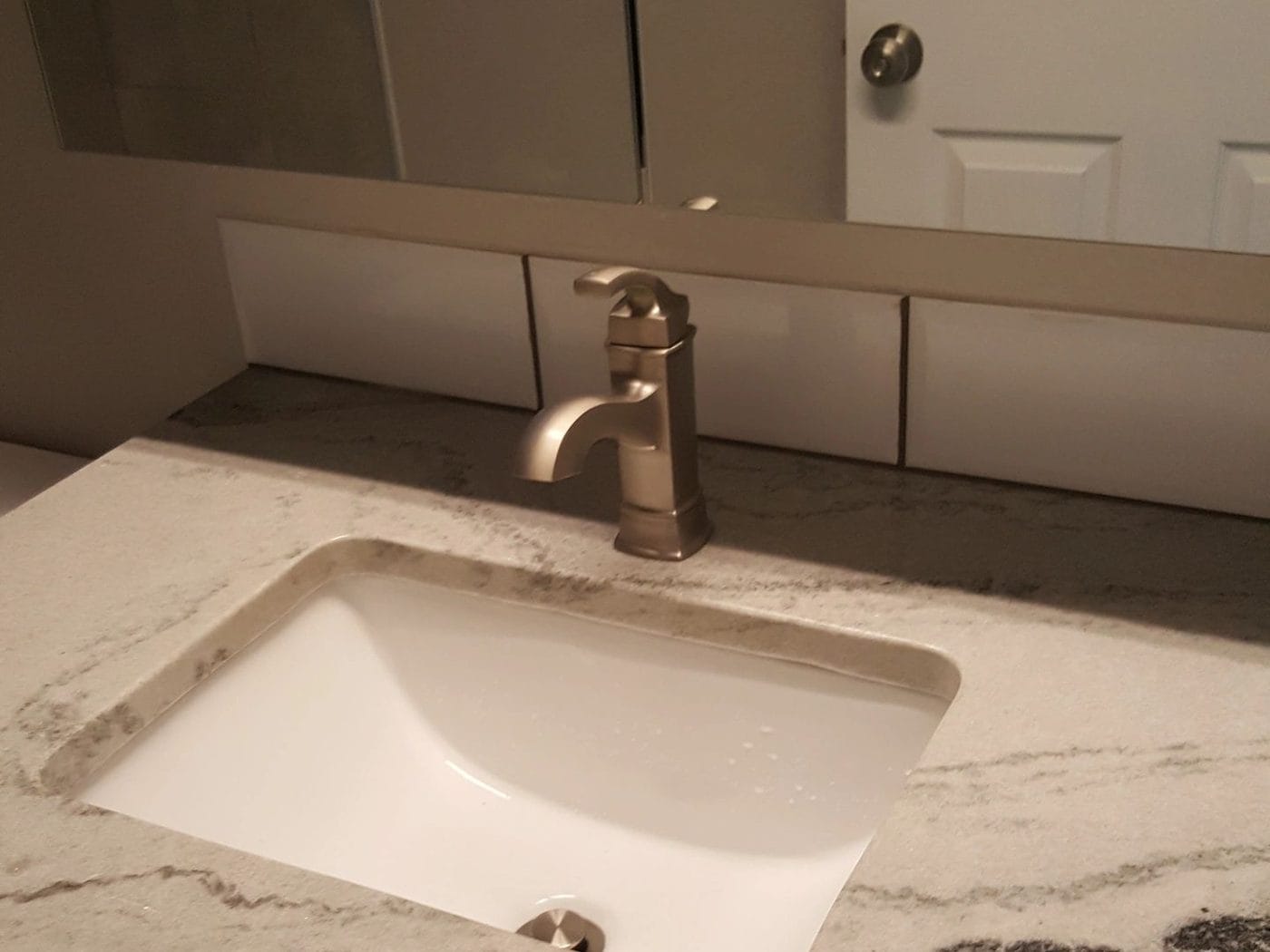 A close view of an undermount basin set into a stone top