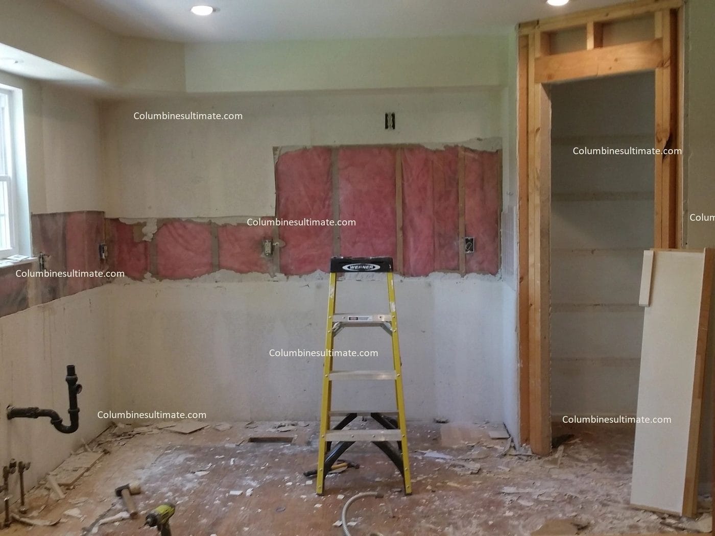 A kitchen mid-remodel with the walls opened up and patched