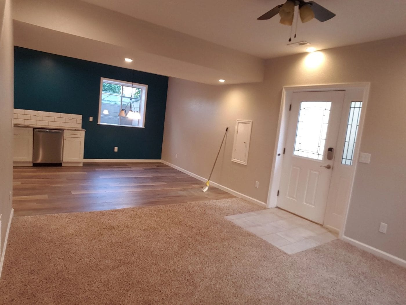 A finished basement with new flooring and an exterior door