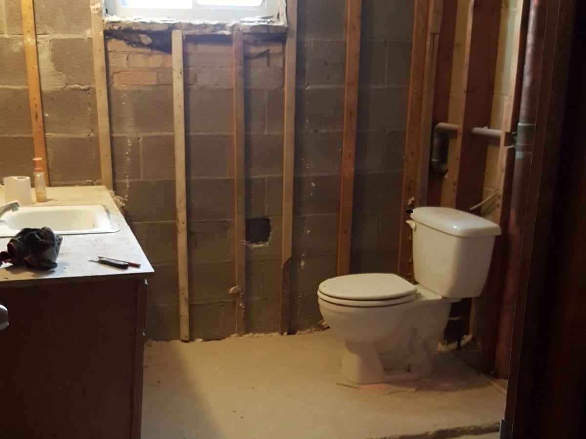 A bathroom stripped back to the framing before new tile goes in