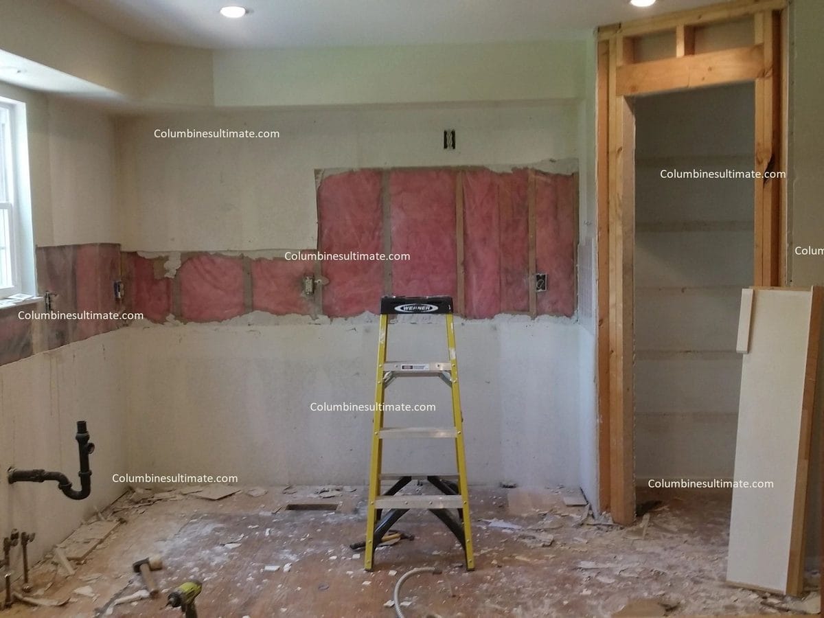 A kitchen wall opened up and patched, ready for paint